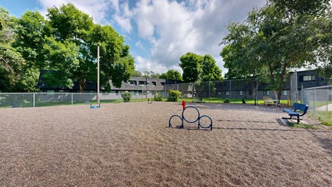 a baseball field with a bike rack in the middle of it and a bench on the side