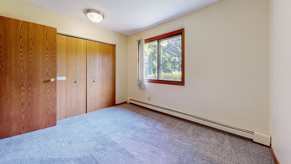 an empty room with a window and a door