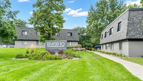 A sign that says River 10 in front of some houses.