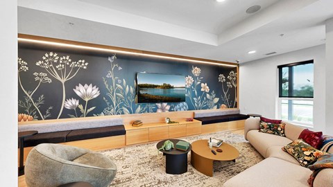 A living room with a large floral mural on the wall.