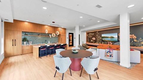 A modern dining room with a round table and chairs.
