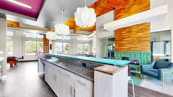 A modern kitchen with a long island and a counter top.