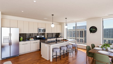 A modern kitchen with a dining table and chairs.