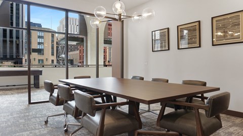 A conference room with a long table and chairs.