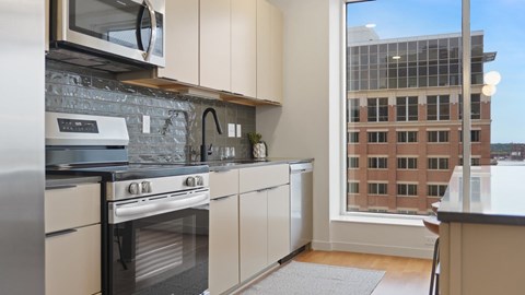 A kitchen with a stove, oven, and microwave.