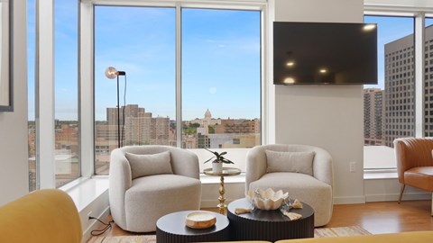 A modern living room with a view of the city skyline.