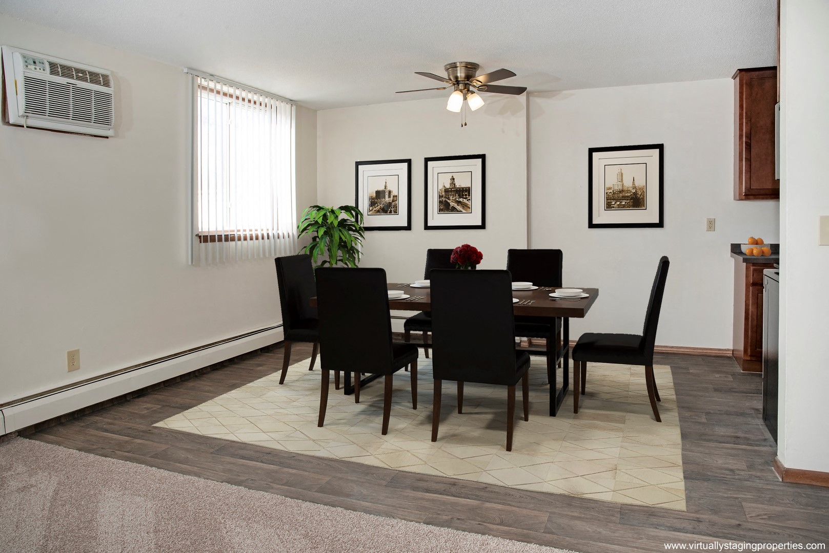 a dining room with a table and chairs and a ceiling fan