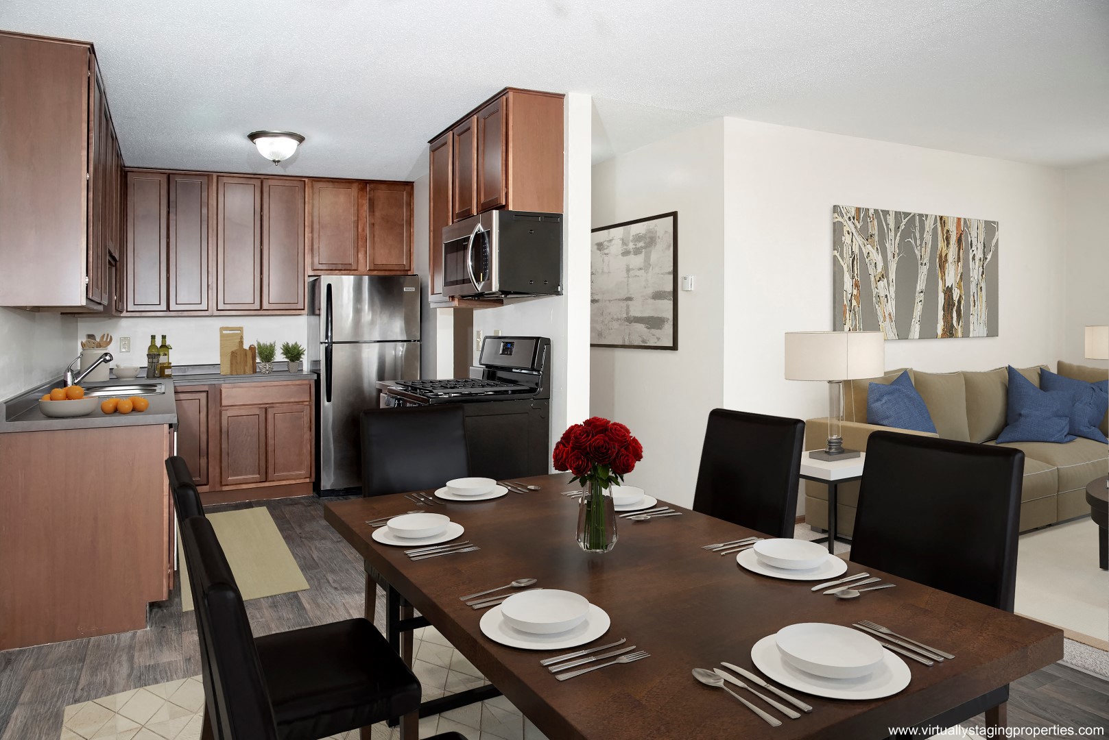 a kitchen and dining room with a wooden table and chairs