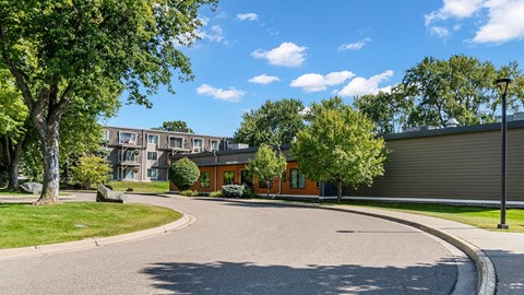 A sunny day at a residential area with a curved road and houses.