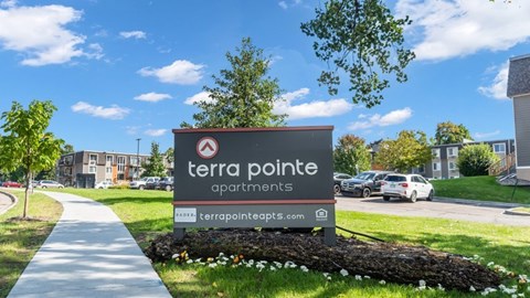 A sign for Terra Pointe Apartments is displayed in front of a building.