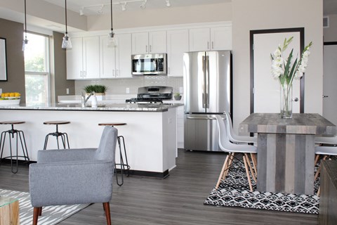 a kitchen and dining area with a table and chairs and a refrigerator