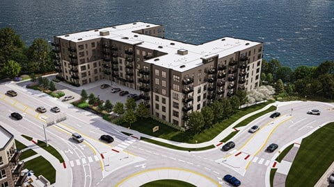 an aerial view of a large building with cars on the road  at The Ansel Residences, Vadnais Heights, 55126