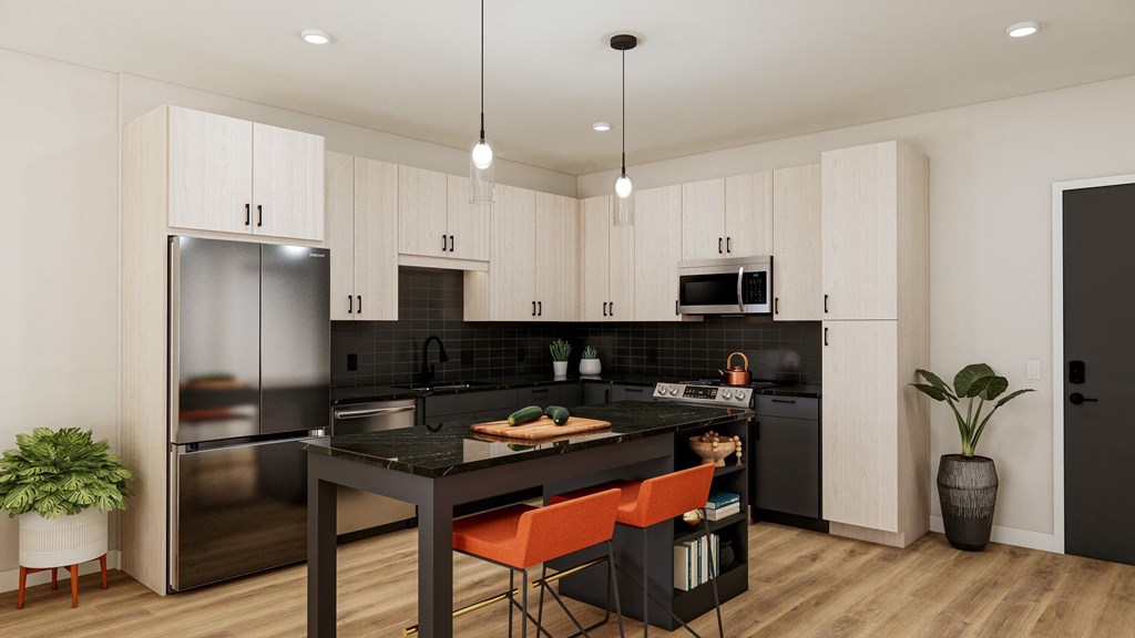 a kitchen with a large island and a stainless steel refrigerator  at The Ansel Residences, Vadnais Heights, 55126
