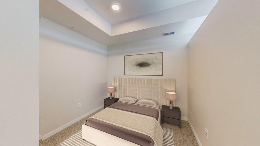 a bedroom with a bed and two lamps