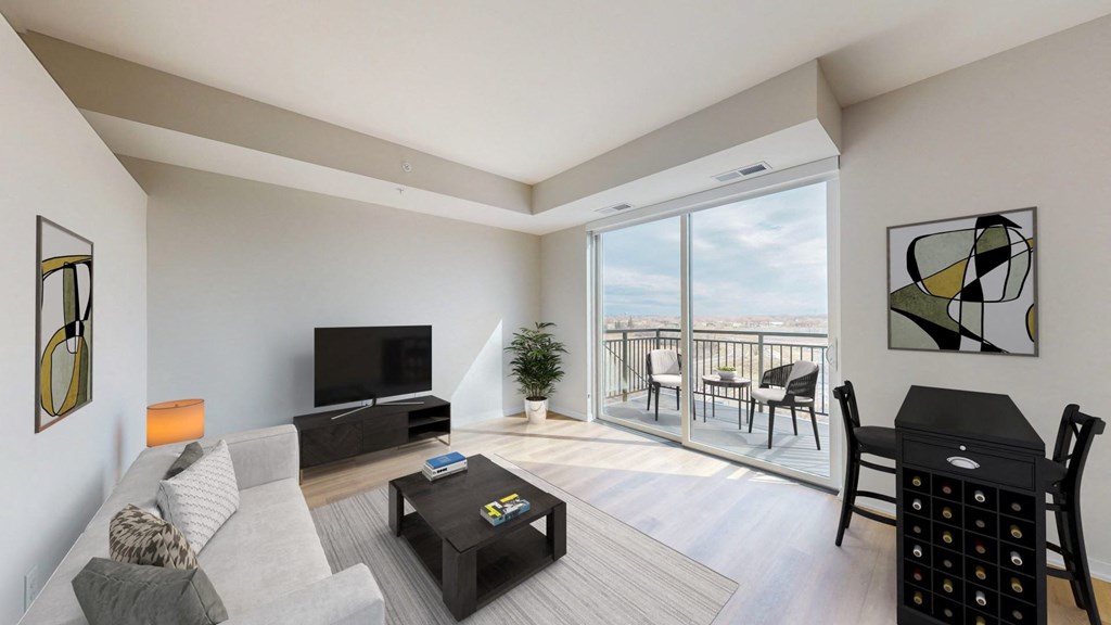 a living room with a couch and a tv and a balcony