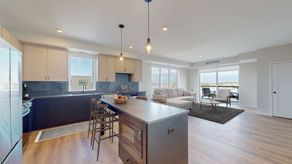 a kitchen with a large island and a living room