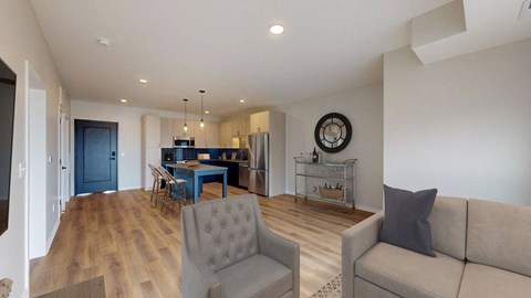 a living room and kitchen with a couch and a table