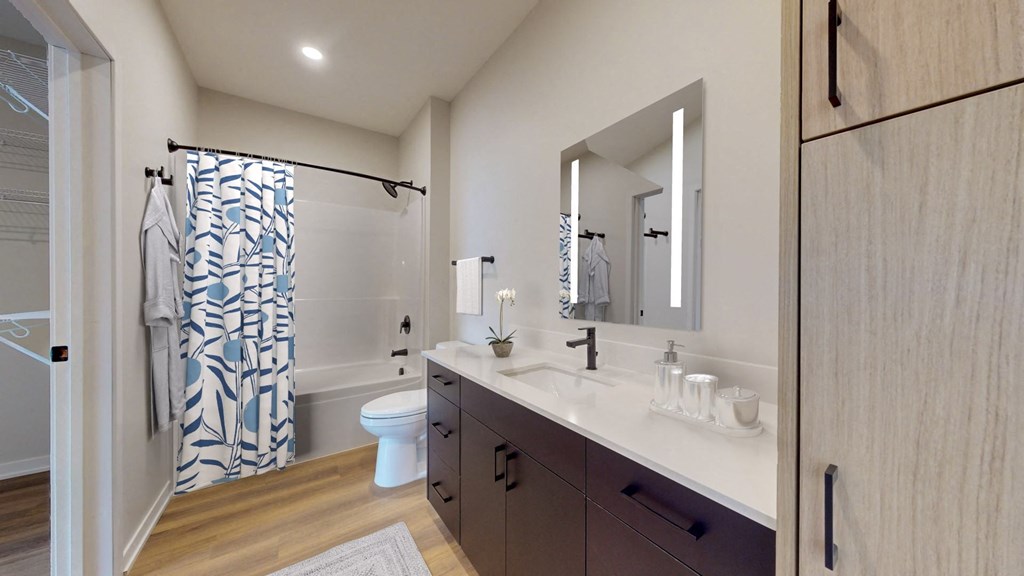 a bathroom with a sink and a shower and a toilet