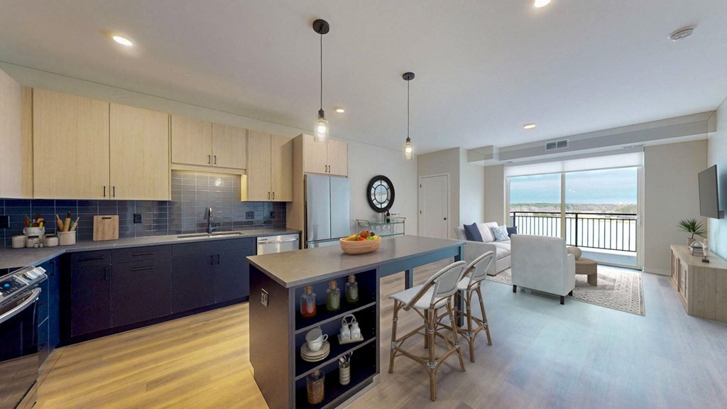 a kitchen with a large island and a living room