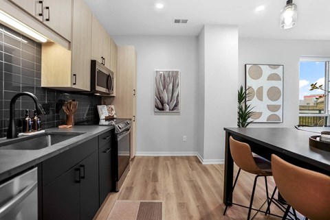 an open kitchen and dining room with a table and chairs