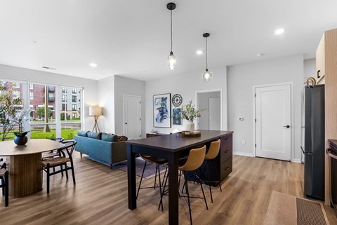 a living room and dining room with a table and chairs