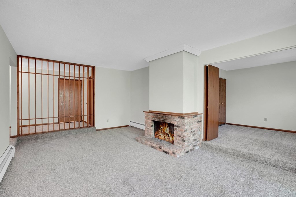 a living room with a fireplace and a wooden door