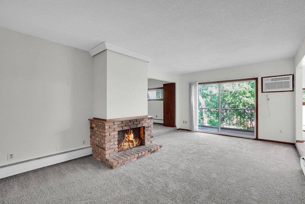 a living room with a fireplace and a glass door