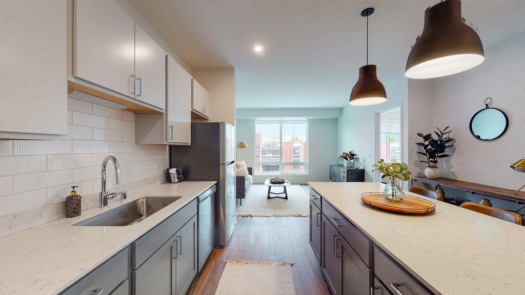 a large kitchen with white cabinets and a sink