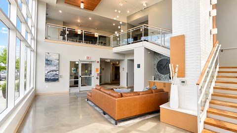 A large open living room with a staircase and a couch.