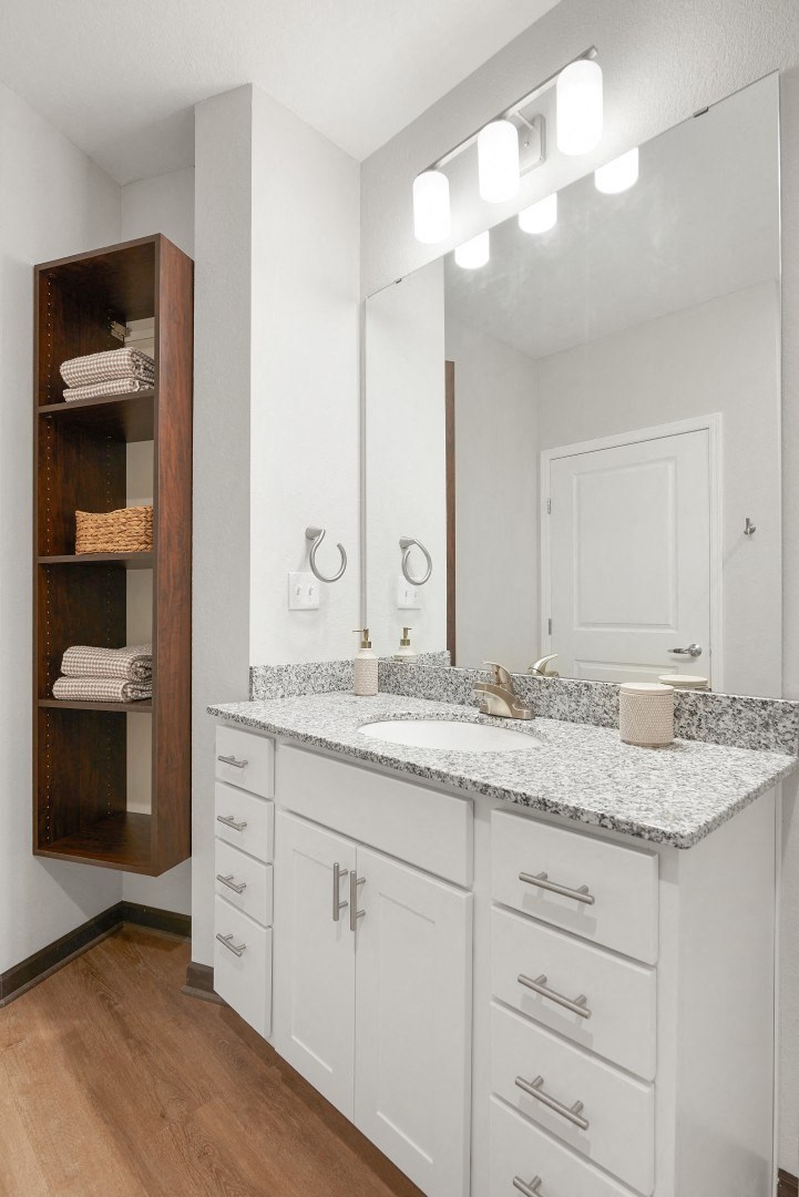 a bathroom with a sink and a mirror at The Yards and Backyards, South St. Paul, MN