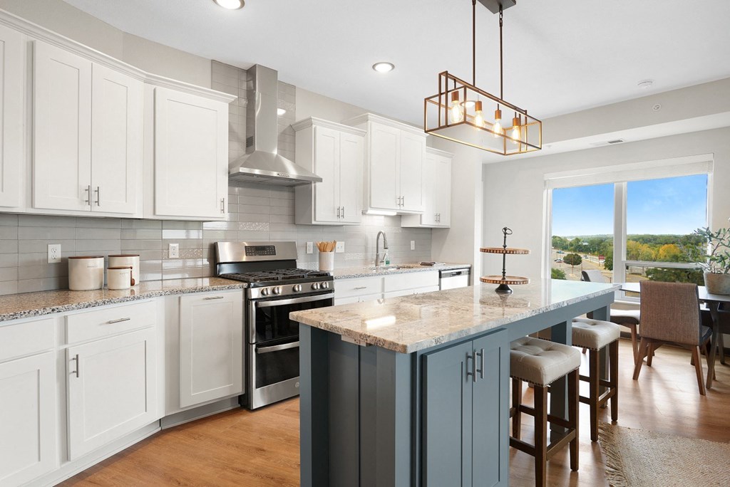 a kitchen with a large island and a stove at The Yards and Backyards, Minnesota