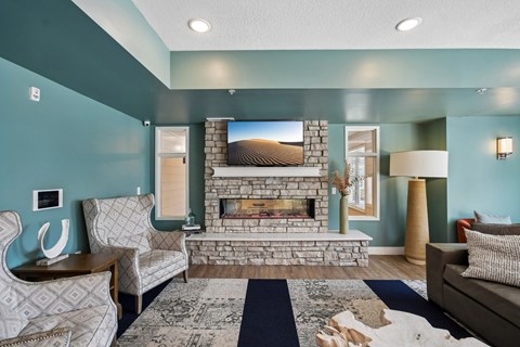 A living room with a fireplace and a painting on the wall.