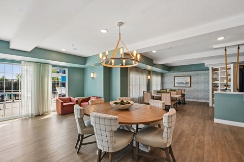 A dining room with a round table and chairs.