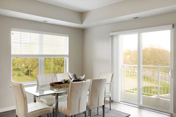 A dining room with large windows at The Barnum Apartments, MN, 55110
