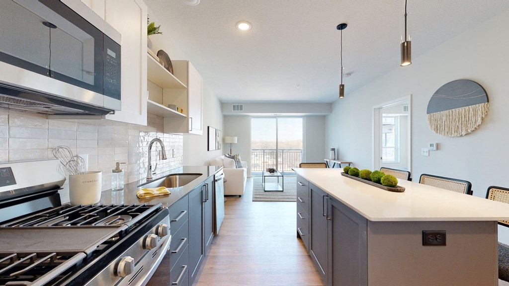 a kitchen with white countertops and blue cabinets