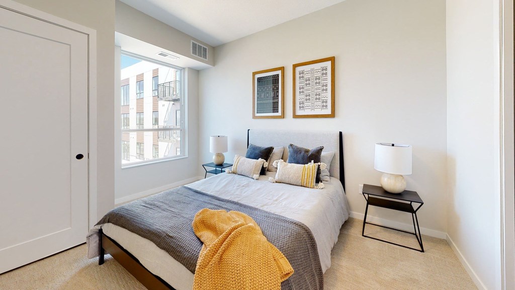 a bedroom with a bed and two lamps