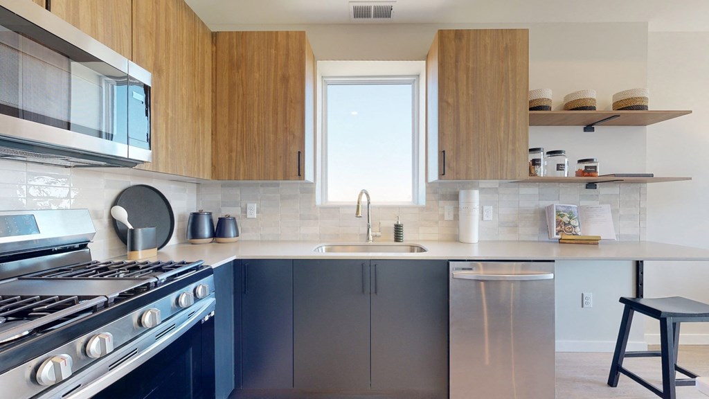 a kitchen with wood cabinets and stainless steel appliances