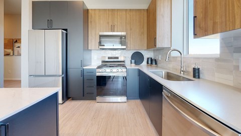 a kitchen with a stove top oven next to a sink