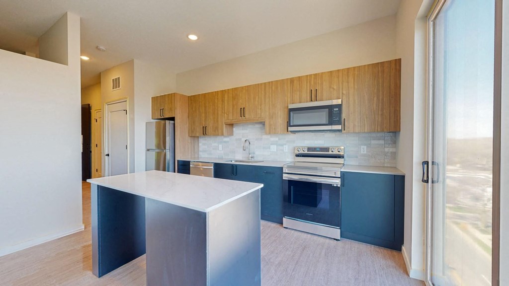 a kitchen with blue cabinets and white countertops