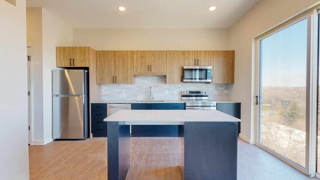 a kitchen with a large island in a 555 waverly unit