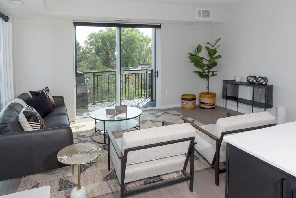 a living room with a sliding glass door that leads to a balcony