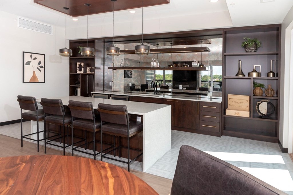 a kitchen with a large center island with a white countertop