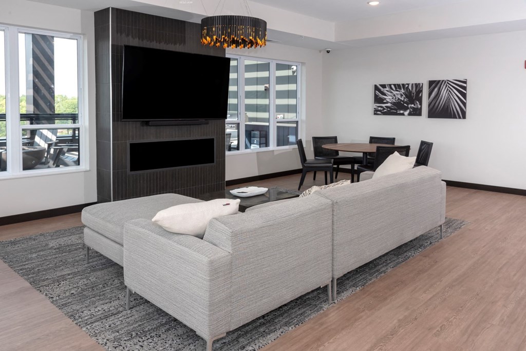 a living room filled with furniture and a large flat screen tv