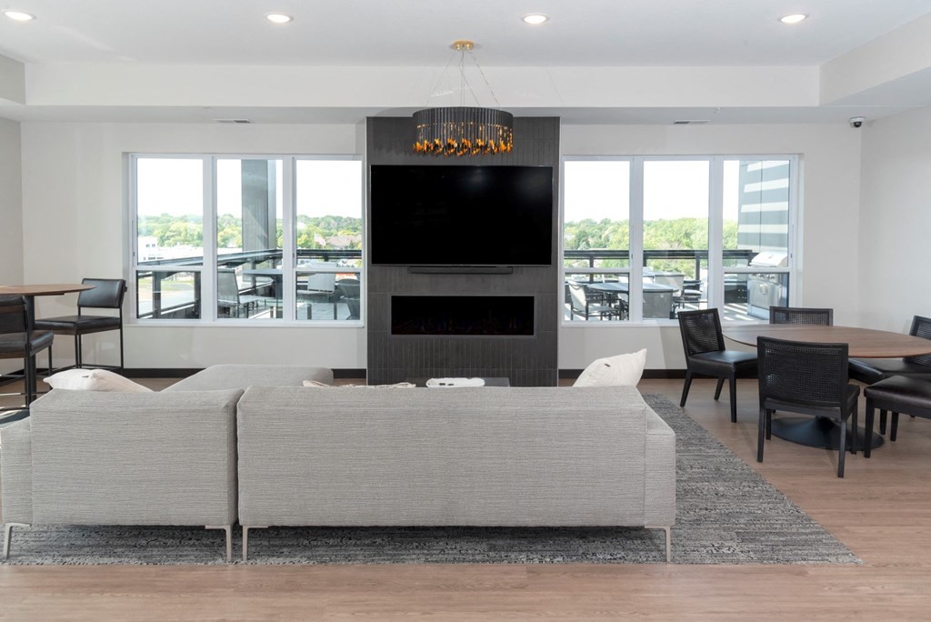 a living room filled with furniture and a large window