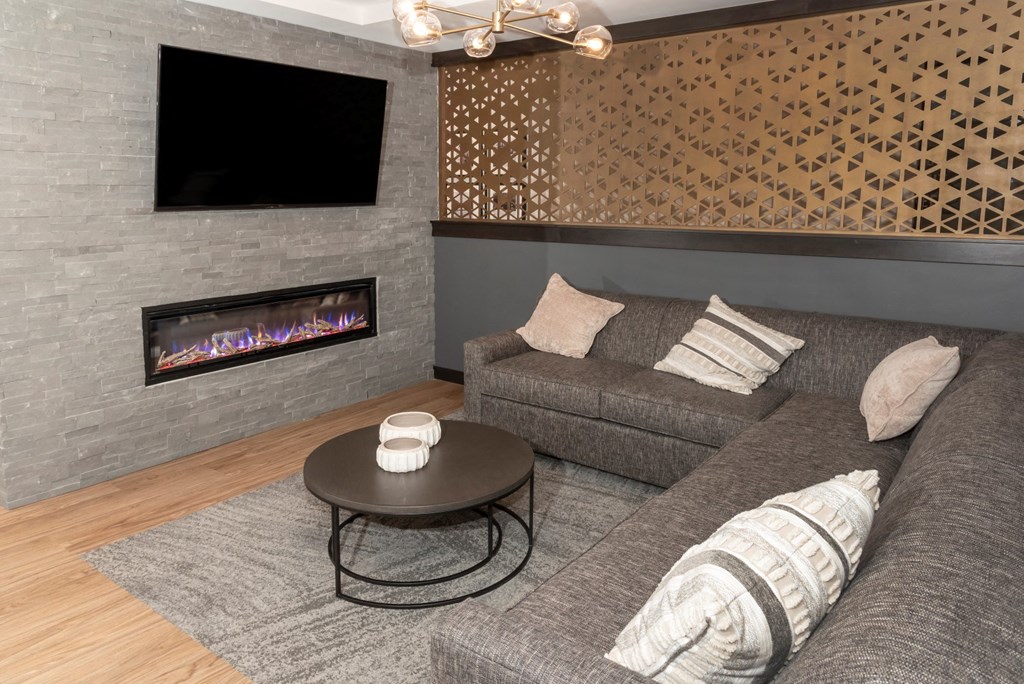 a living room with a couch coffee table and fireplace