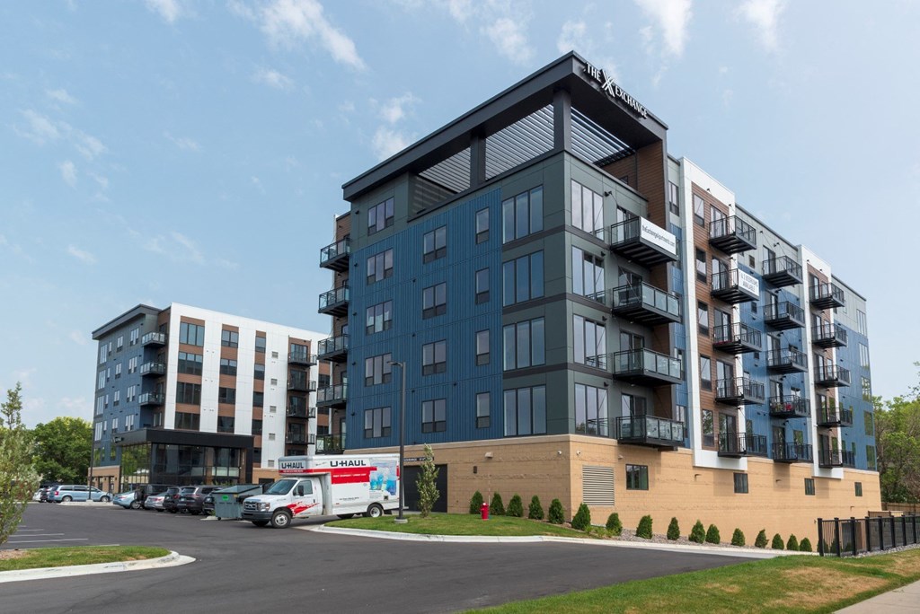 an apartment building with a truck parked in front of it