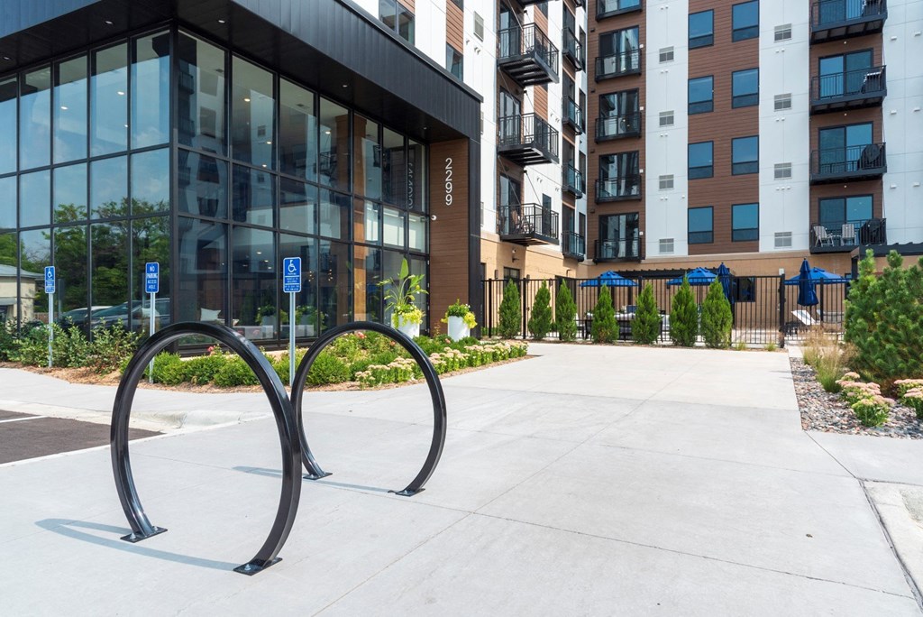 a bike rack in front of an apartment building