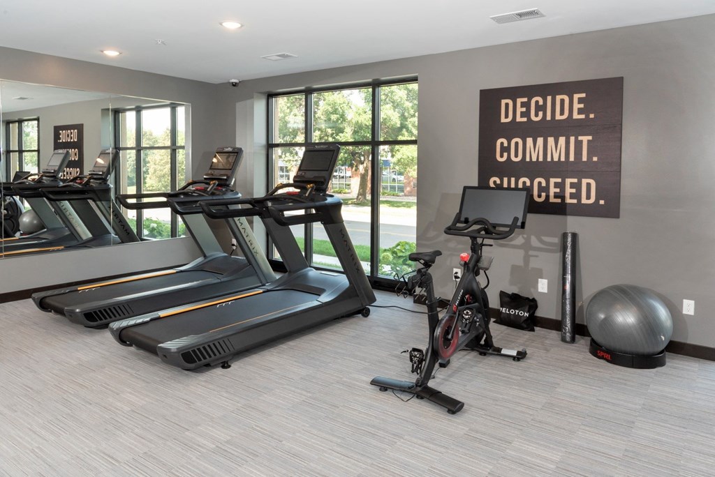 a gym with treadmills and other exercise equipment