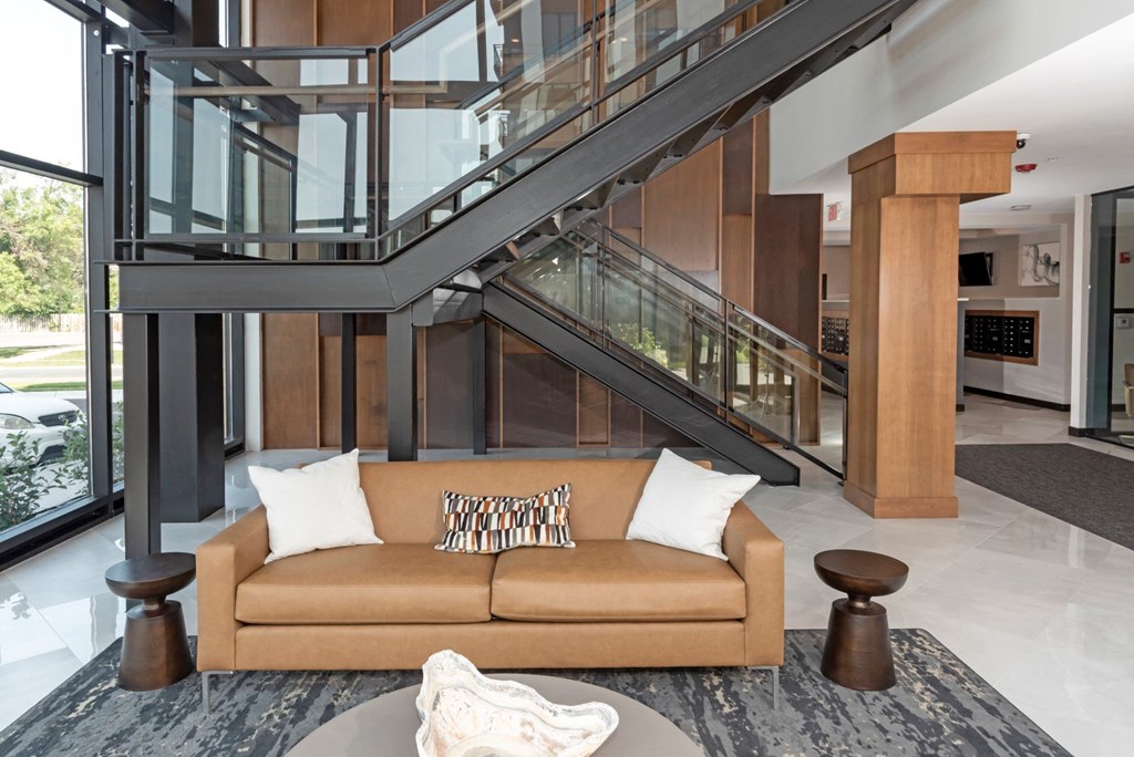 a living room with a couch in front of a staircase