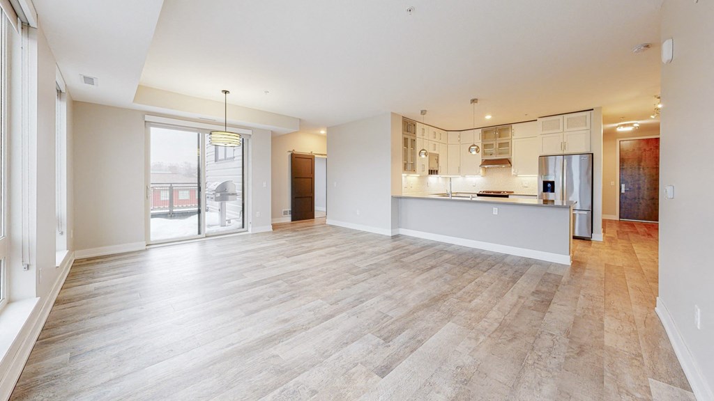 a kitchen and living room with a wooden floor